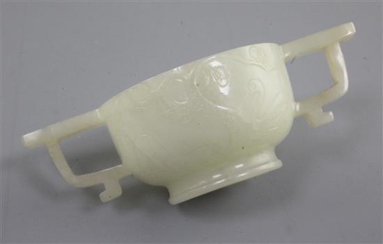 A Chinese pale celadon jade two handled cup, 17th / 18th century, 10.3cm
